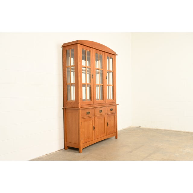 An exceptional Mission or Arts & Crafts lighted breakfront bookcase cabinet, dining cabinet, or display cabinet In the...