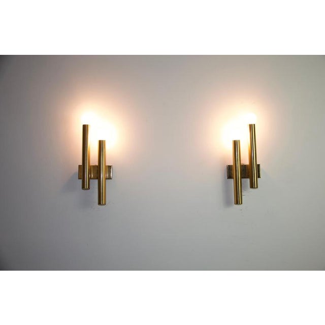 This elegant pair of wall lamps was designed by gaetano sciolari in italy during the 1960s. characteristic of sciolari’s...