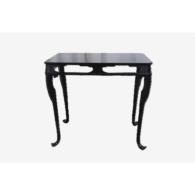 A sophisticated ebony lacquer tea table by Baker Furniture, blending elegant Asian-inspired lines with the brand’s...