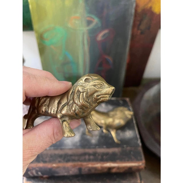 Charming pair of brass lions, each slightly different, they look nice displayed together. One is larger than the other,...