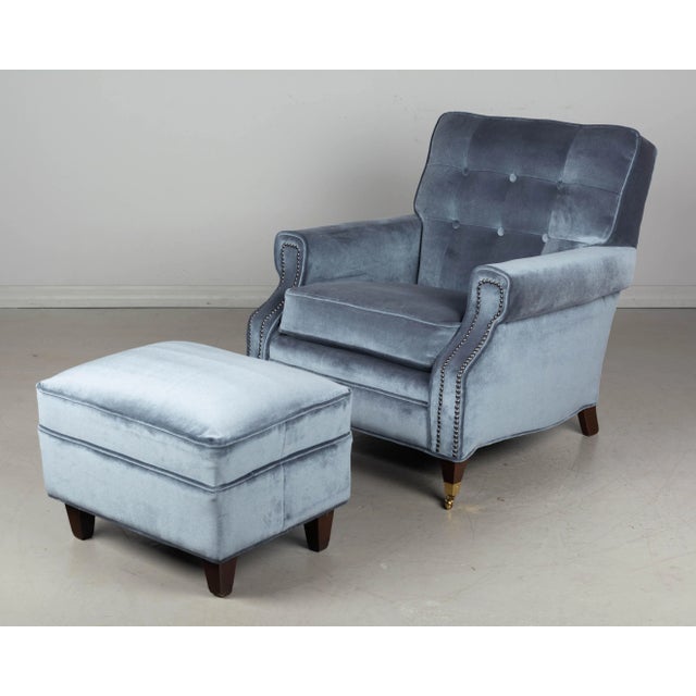 A Mid Century club chair and ottoman upholstered in Sunbrella slate velvet. A comfortable small scale lounge chair...