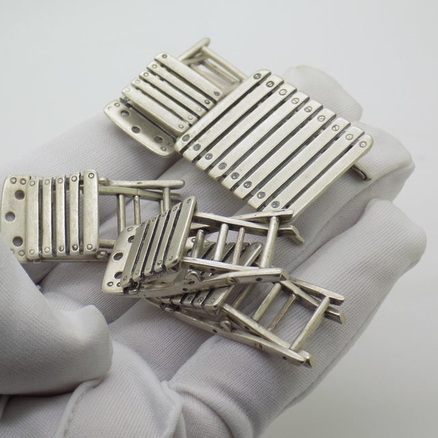 This rare vintage silver collectible set features a miniature dollhouse outdoor furniture suite consisting of 4 folding...
