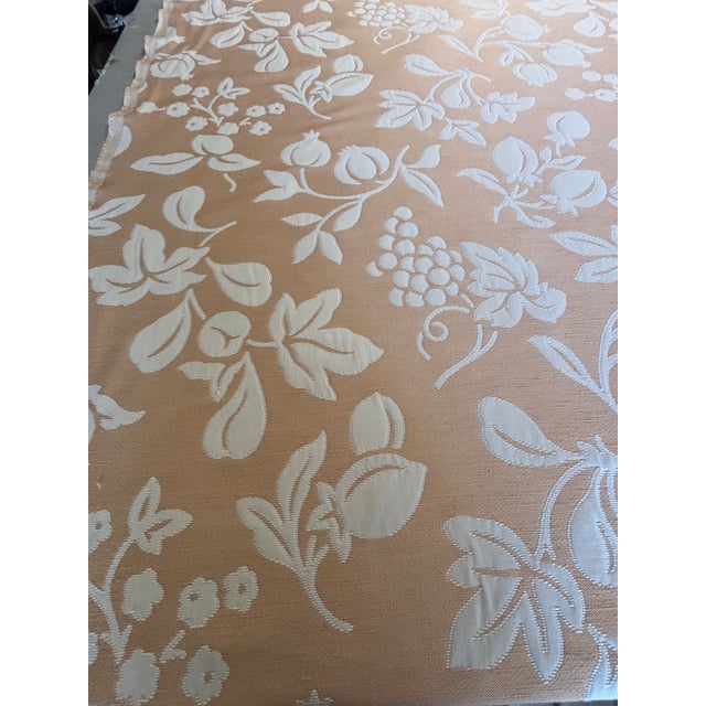 Over 25 yards of peach and cream upholstery weight cotton fabric featuring a pretty fruit and flower pattern.