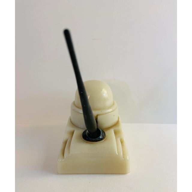 This is a marvelous inkwell with pen holder in cream colored milk glass by 'Sengbusch'. Marked on back with Sengbusch...