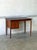 This elegant writing desk features a streamlined rectangular profile elevated by sleek tapered legs. The practical design...
