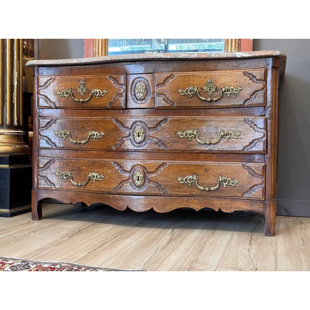 An 18th C. Continental serpentine front commode with a molded rouge and gray marble top over three rows of drawers, two...