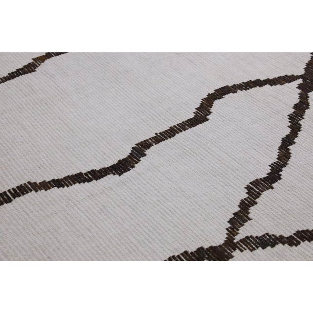 Introducing our exquisite handwoven wool modern Moroccan-style rug, a stunning blend of traditional craftsmanship and...