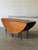 This versatile dining table features a space-saving drop-leaf design that expands into a large oval profile. The elegant...