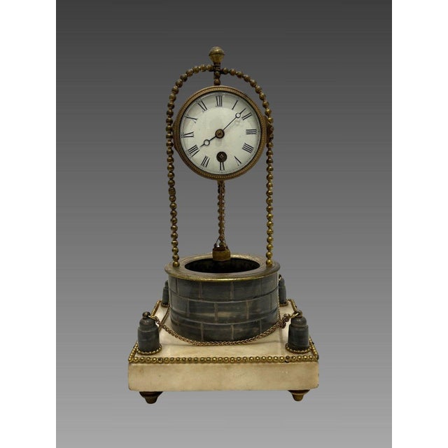 Louis XVI period well clock, late 18th century. A well-shaped clock in gilt bronze and blue Turquin marble. It rests on a...