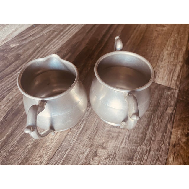This set was likely produced by Johnson Bros Co in the 1930’s labeled as a “set of small pitchers. They were most commonly...