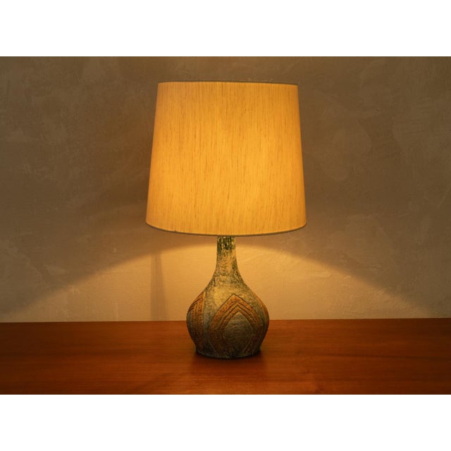 Handcrafted table lamp from the 1970s. High-quality ceramic base with a lampshade in cream. Quality features: very good...