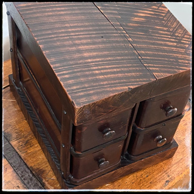 An exceptional 1900s antique American Edwardian-era treadle sewing machine cabinet drawer bank, masterfully repurposed as...