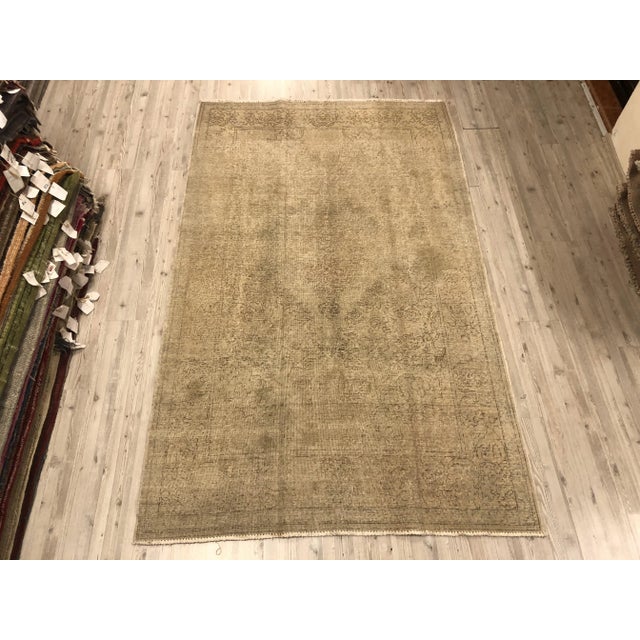 This is a vintage Turkish Oushak rug from the 1960s. The piece was hand-knotted.