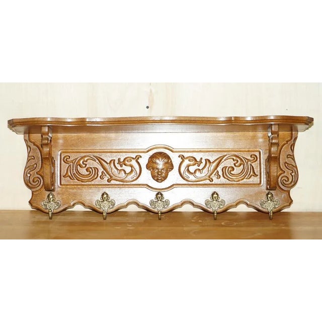 This lovely, heavily carved Dutch oak wall hanging coat hat and scarf rack with French Royalty head gold gilt brass hooks...
