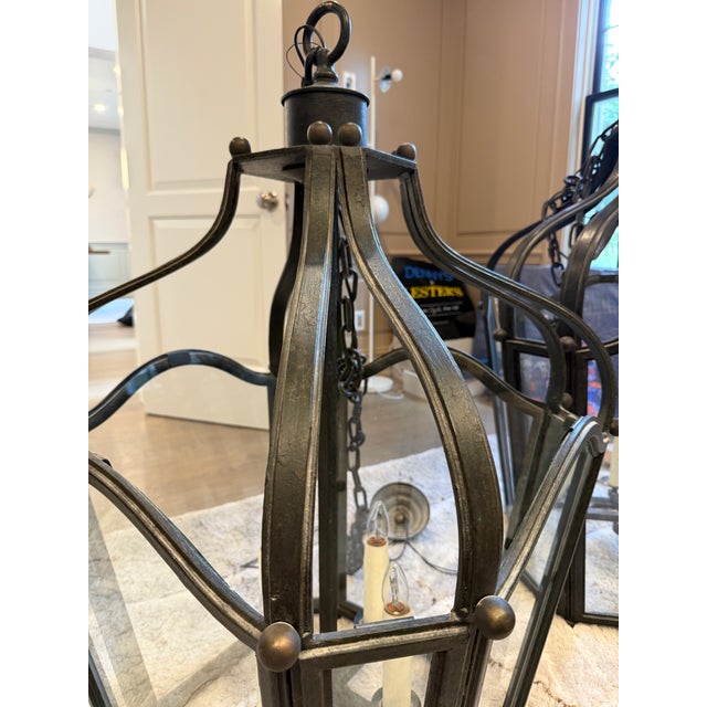 A matched pair of Dennis & Leen Navarre Lanterns in the signature Navarre finish with clear glass panels. Both feature the...