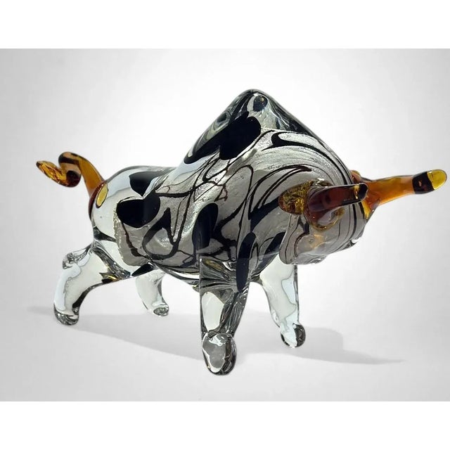 A stunning hand-blown Murano glass sculpture representing a bull, masterfully crafted on the island of Murano using the...