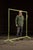 Painted steel garment rack with a simple pipe-frame construction, featuring upright posts joined by a straight hanging bar...