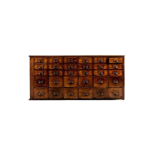 A large pair of 19th century mahogany apothecary cabinets with a total run of sixty smooth running drawers. Each of the...
