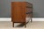 A mid century modern walnut dresser with rosewood drawer pull accents designed by Kipp Stewart for Directional by Calvin....
