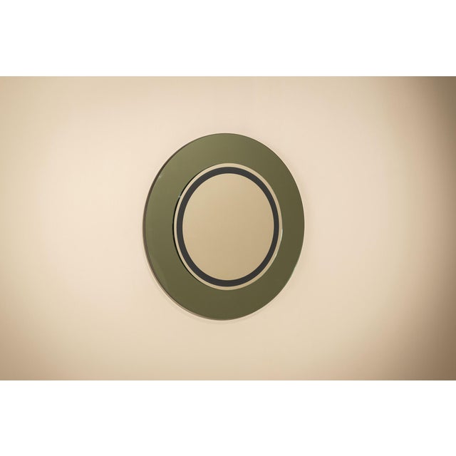 A study in circles, colour and reflection, this wall mirror by marcello and marco de carli turns a functional object into...