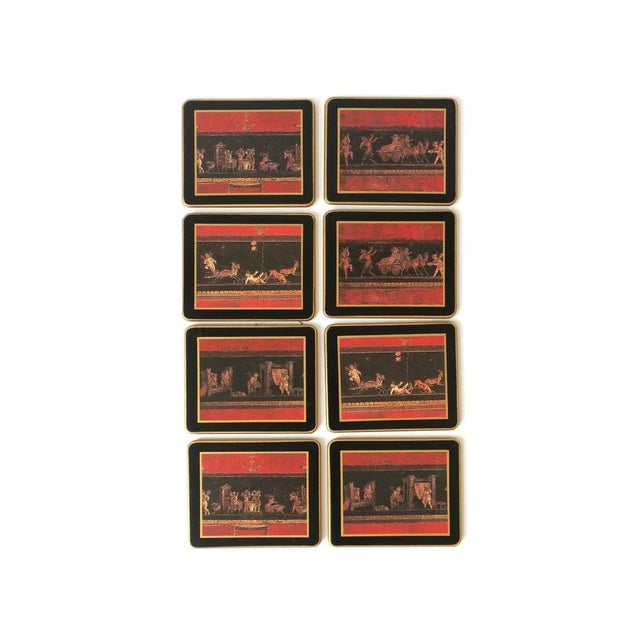 A set of eight (8) black, red, and gold Champagne, wine, cocktails, etc., coasters from English luxury brand Asprey &...