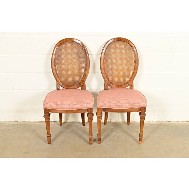 A gorgeous pair of French Regency Louis XVI style side chairs or dining chairs By Drexel USA, Circa 1960s Carved solid...