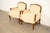 A gorgeous pair of French Provincial Louis XV style bergère lounge chairs By Baker Furniture USA, Circa 1980s Carved...