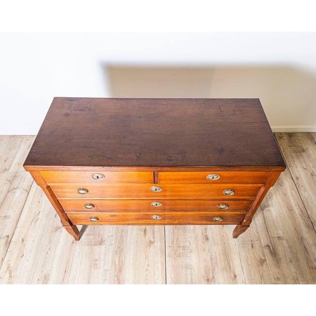 This elegant chest of drawers from the Directoire period, crafted in solid walnut, dates to the late 18th century and...