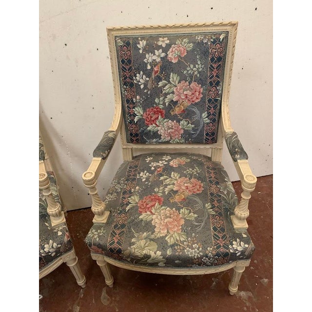 Pair of louis xvi style armchairs in white lacquered beechwood four fluted, turned legs upholstered armrests upholstery...