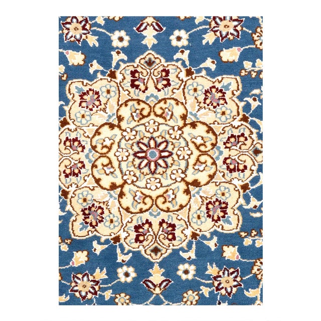 Persian Nain rugs are renowned for their detail and fine use of outlining along the central motifs. Breaking from the...