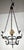 This is a rustic wrought iron chandelier with a medieval-inspired design. It features a circular frame supported by four...