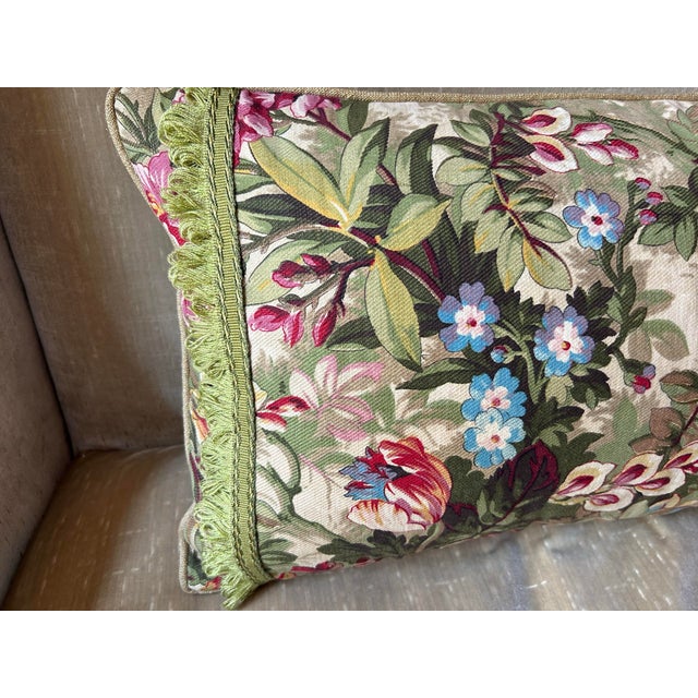 A pillow made from a circa 1920s French printed cotton,backed with coordinating raw silk and embellished with vintage...