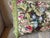 A pillow made from a circa 1920s French printed cotton,backed with coordinating raw silk and embellished with vintage...