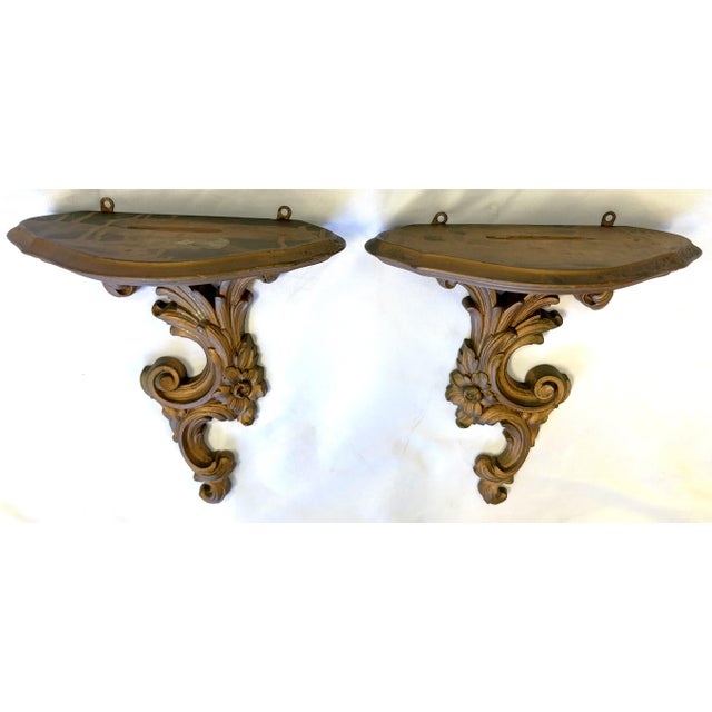 Pretty vintage pair of decorative wall brackets from the mid 20th century. They're made of wood and finished in a rich...