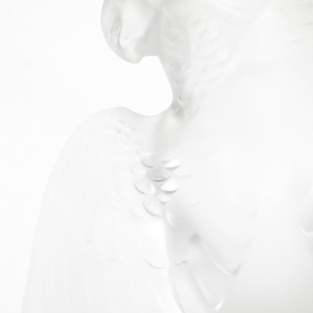 This elegant Mid-Century Modernist crystal cockatiel sculpture, signed by Lalique and crafted in France circa 1950, is a...
