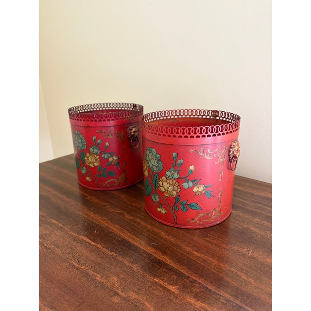 A wonderfully charming pair of early 20th century French tole cachepot finished in a rich cinnabar red with delicate...
