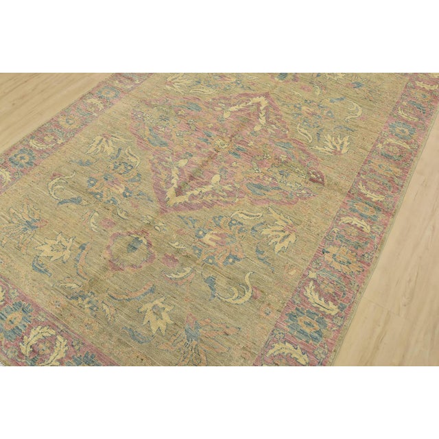 A modern traditional Ziegler rug hand-knotted with fine wool on a cotton foundation. This rug features a subtle central...
