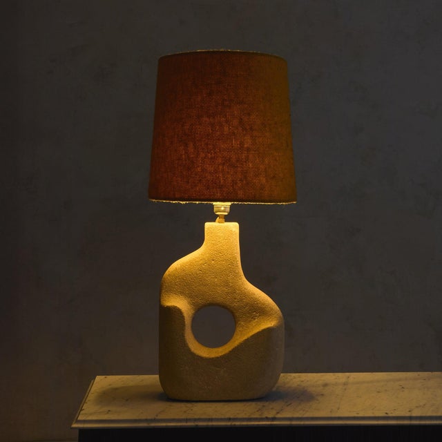 A French abstract limestone table lamp by Albert Tormus, dating to the 1960s. The base is carved from pale limestone, its...