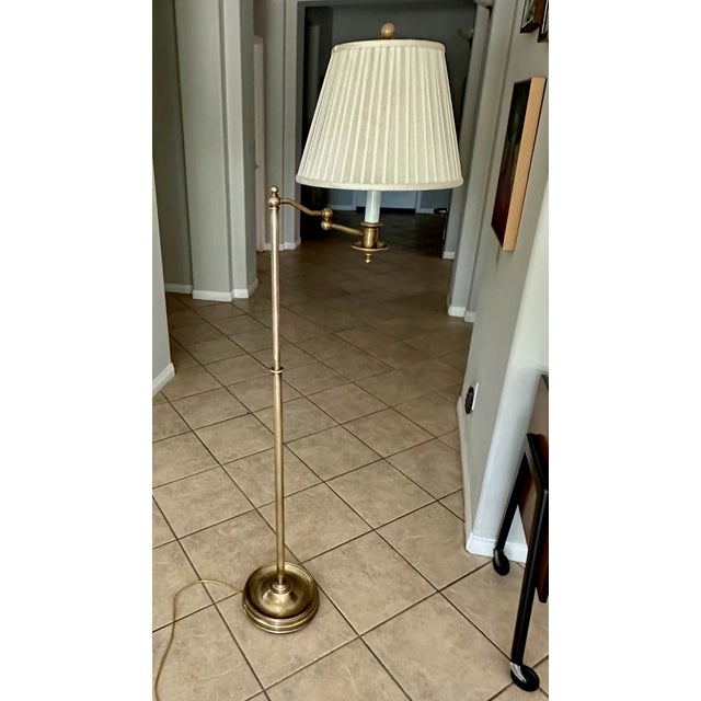 "Sargent" brass swing arm brass floor lamp, Ralph Lauren Home, c.2001, on weighted stepped base. Brass more recently...
