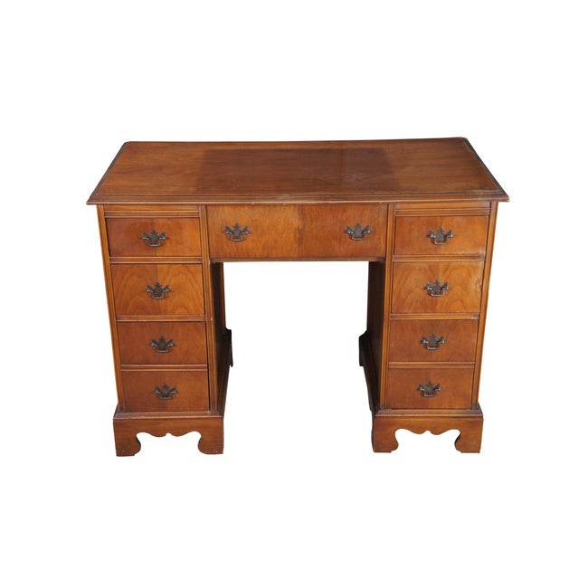 1940s American writing desk in Georgian / Chippendale Styling. Features a matchbook walnut frame with a typewriter drawer...
