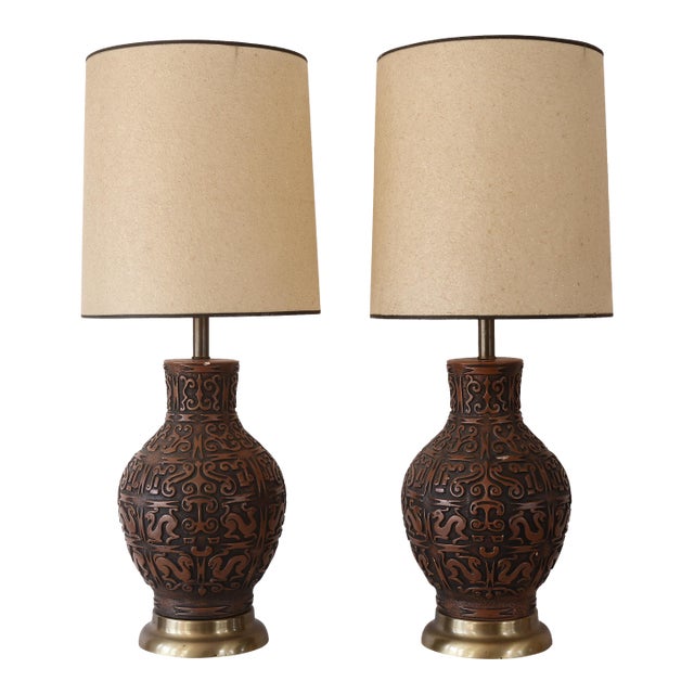 Absolutely gorgeous pair of vintage mid century ceramic lamps with relief art mimicking sgraffito woodwork. The lamps are...
