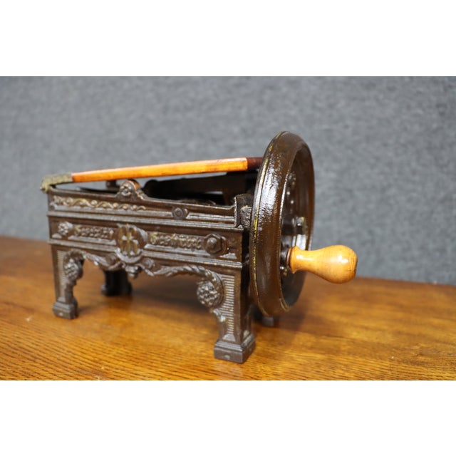 Antique Victorian cast iron tobacco cutter featuring an ornate molded body with decorative scrollwork, floral rosettes,...
