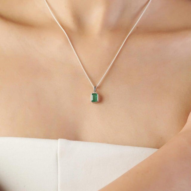 Featuring a 5×7 mm octagon-cut emerald gemstone weighing 0.95 carats, this pendant is crafted in 925 sterling silver with...