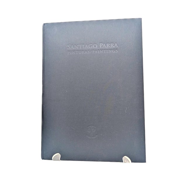 Offered is a bound edition of a blingual (Spanish and English) art catalogue of the 2010 exhibition of Santiago Parra's 17...