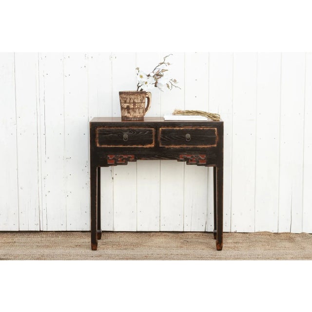 Qing Dynasty style console table, a masterpiece characterized by clean lines and a simple apron adorned with a pair of...