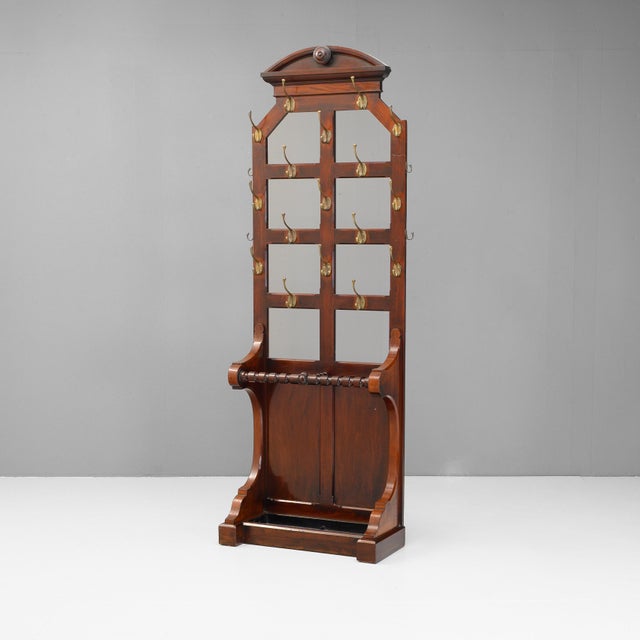 Mahogany hallstand with brass hooks and tray base. Circa 1890.