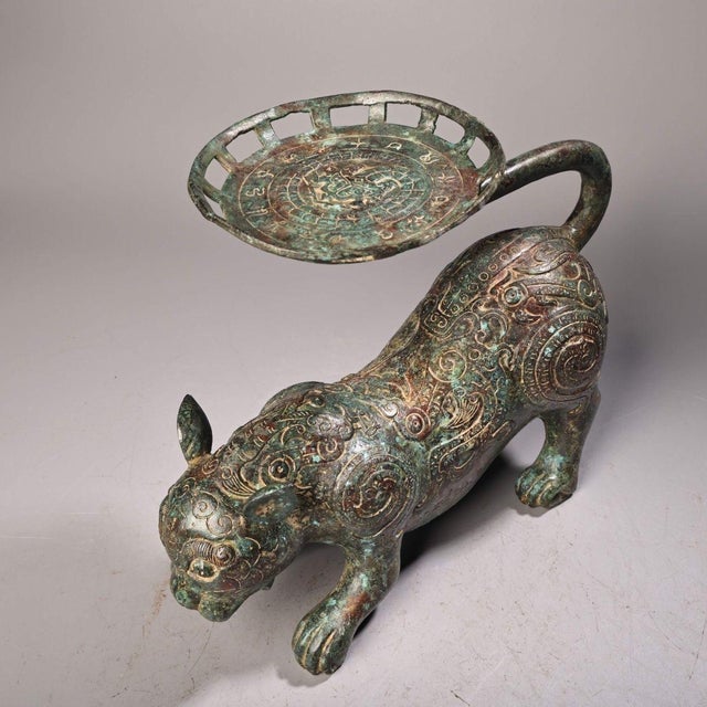 This is a cast bronze sculptural stand or fruit tray in the form of a standing tiger. The tiger is depicted in a dynamic,...