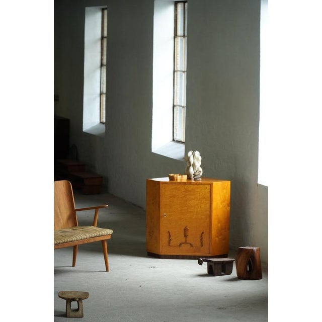 An elegant Swedish Art Deco corner cabinet crafted in beautifully figured birch veneer during the 1930s. The cabinet is...