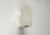 Rare wall light from Erco. A minimalist design. The cylindrical shade is made of plastic. It features a ribbing all...