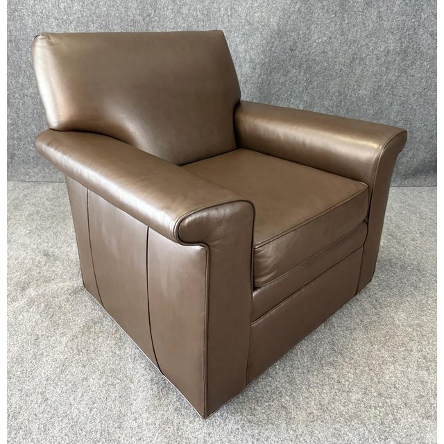 This Jessica Charles Leather Swivel Club Chair combines timeless design with modern functionality, wrapped in smooth,...